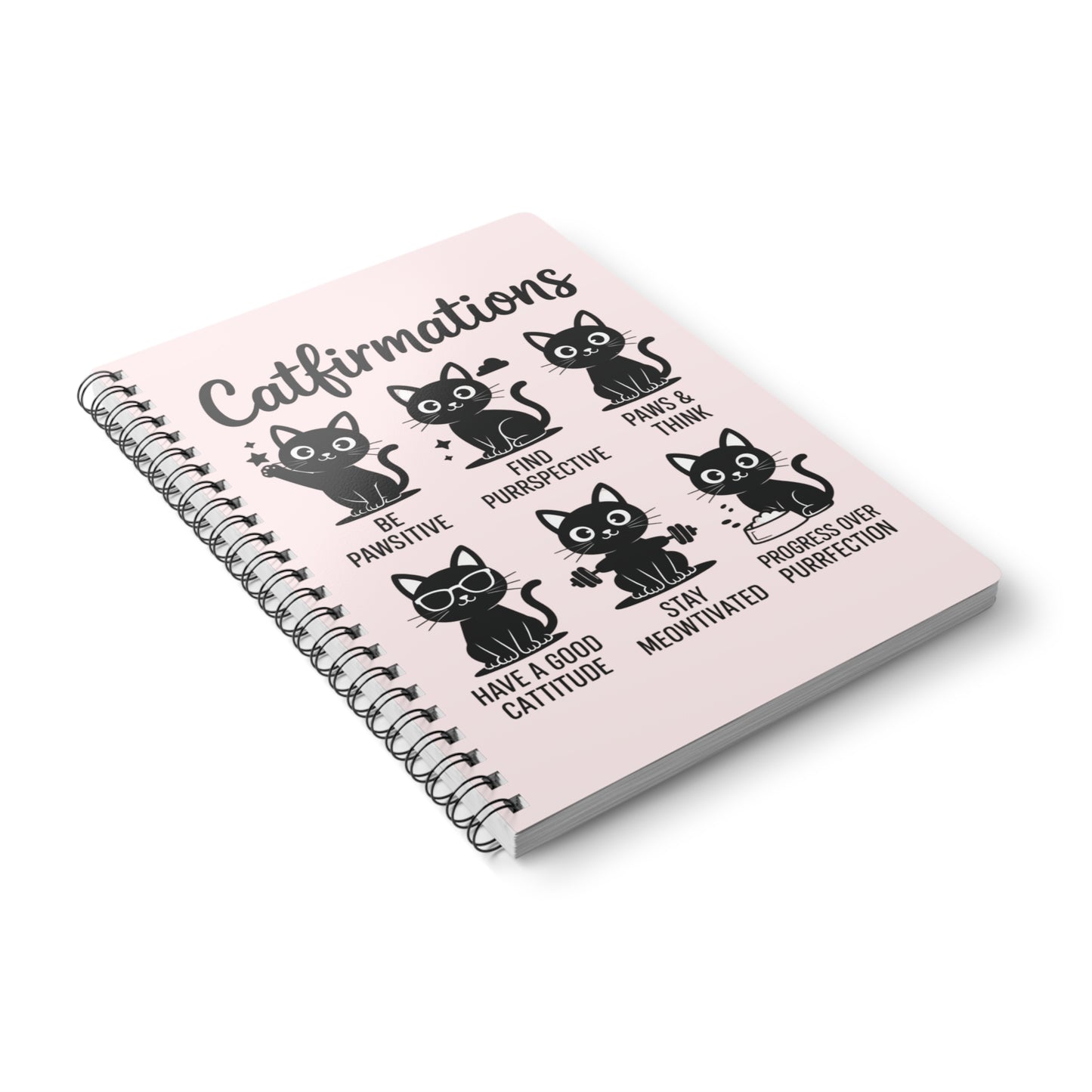 Notebook with black cat illustrations and text on a pink background