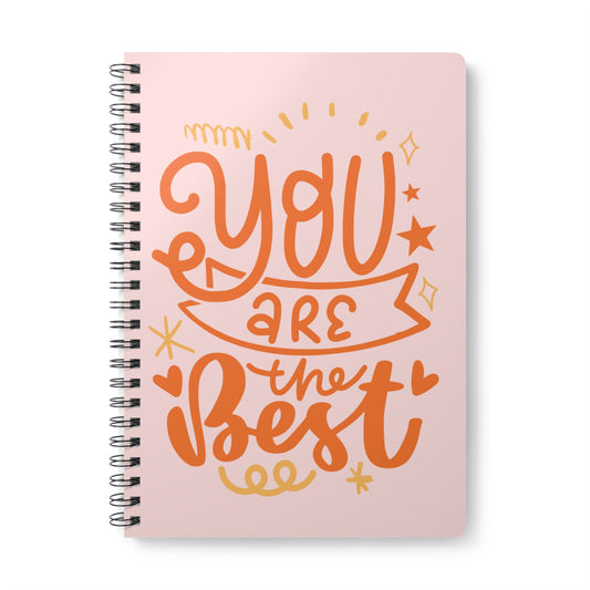 Pink notebook with 'You are the best' text on a white background
