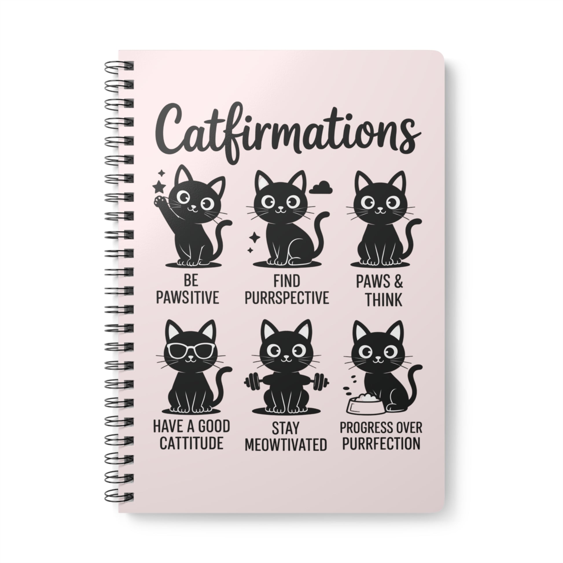 Notebook with cat-themed affirmations on a pink background