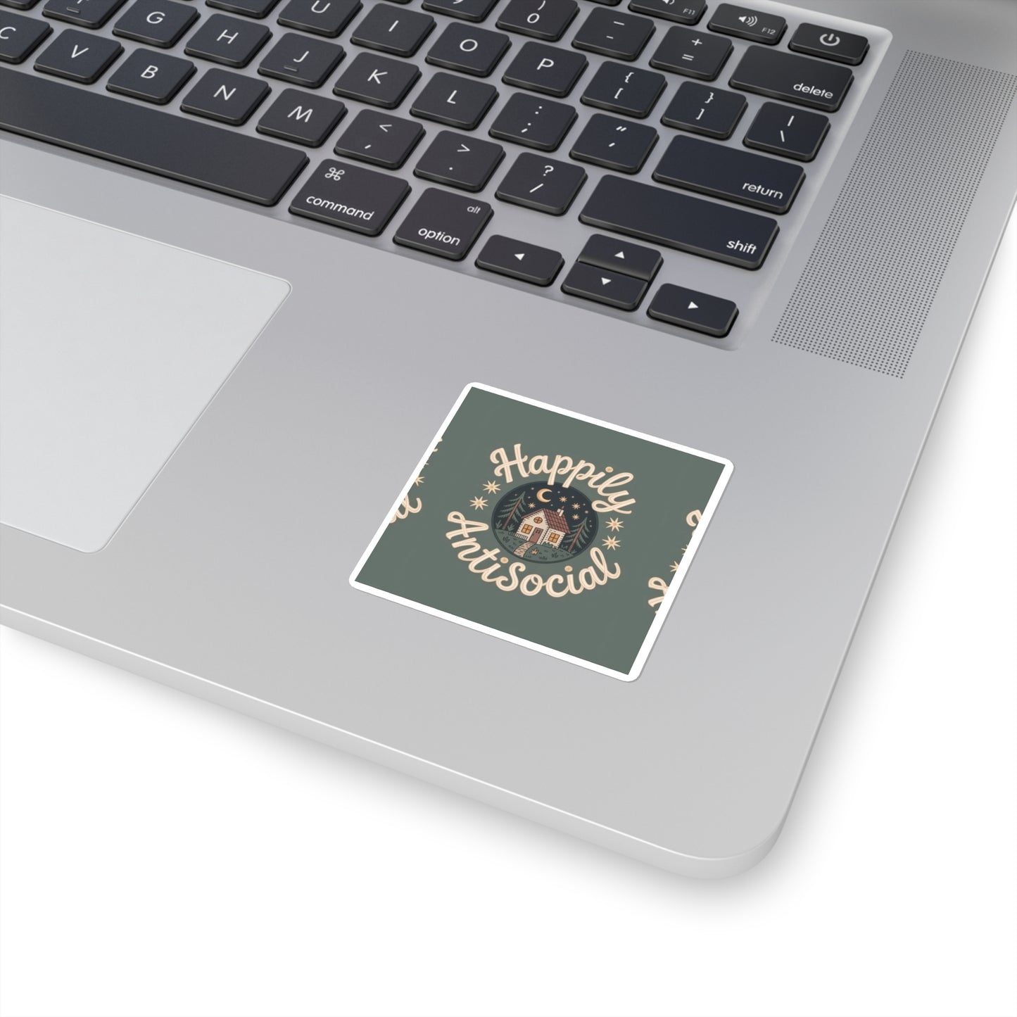 Laptop with a sticker that reads 'Happily AntiSocial' on the palm rest area.
